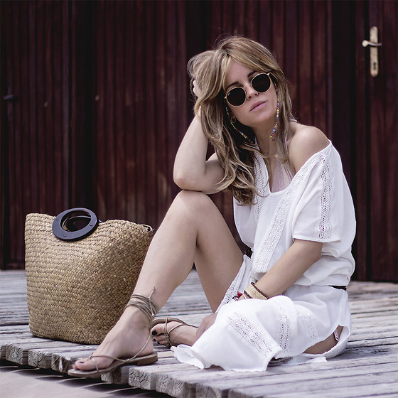 Girl sitting in white beach dress